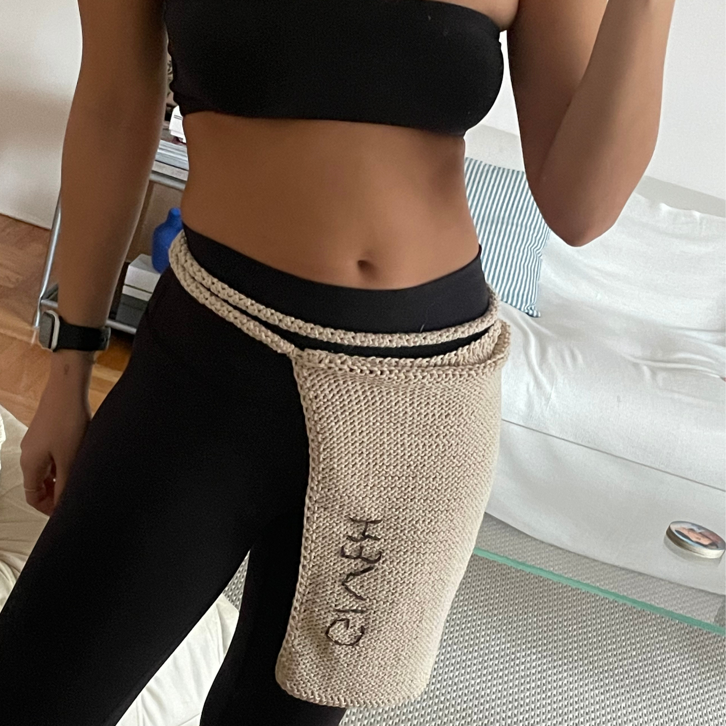 Givéh knitwear cotton hand crocheted crossbody bag by female artisans in Iran, adjustable strap, natural undyed cotton yarn. worn as a skirt.