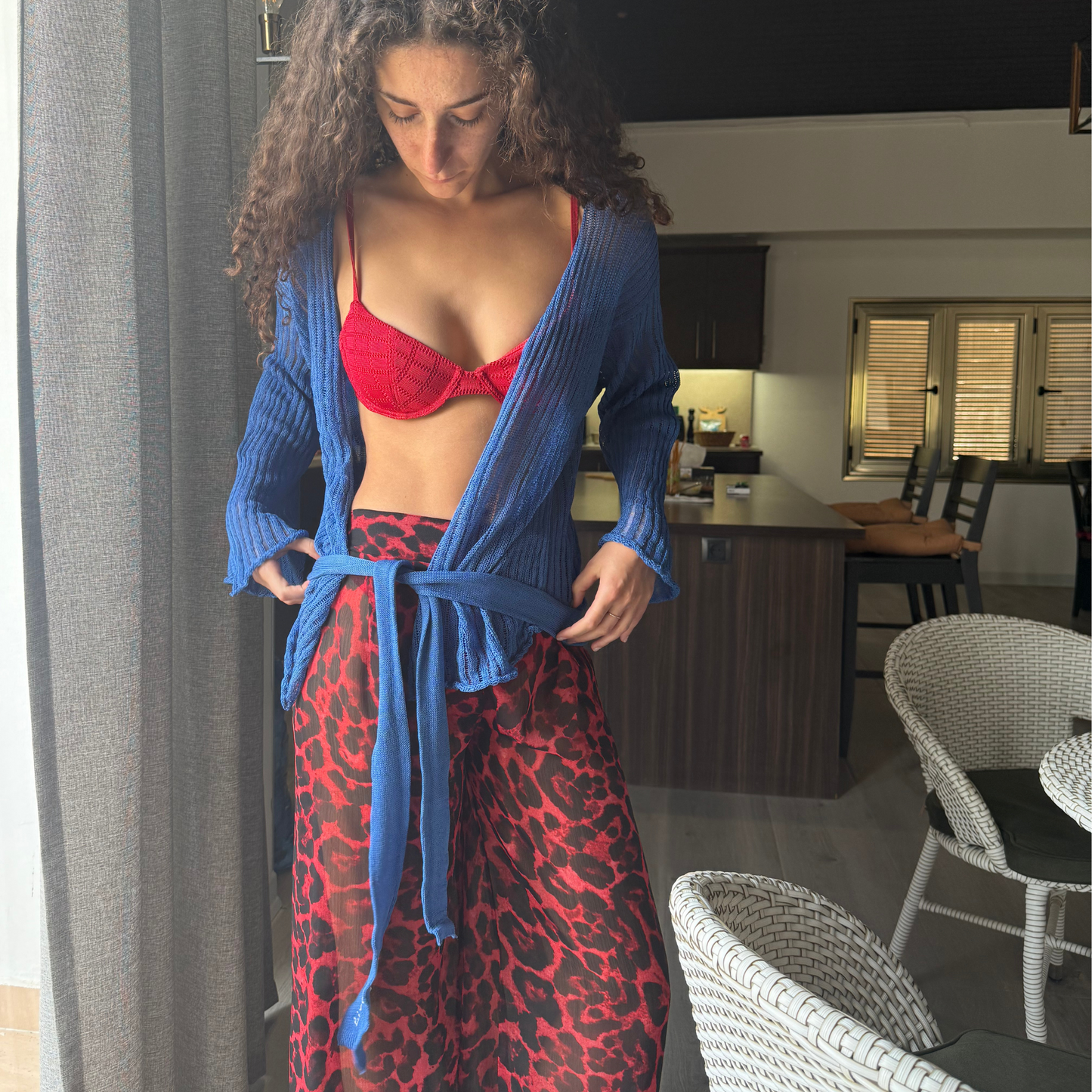 givéh knitwear handmade by female artisans in iran using only natural and recycled fibres. contemporary knitwear for cool people. darya cardi, blue knit cardigan with belt made of organic cotton yarn. spring summer 2025 collection.