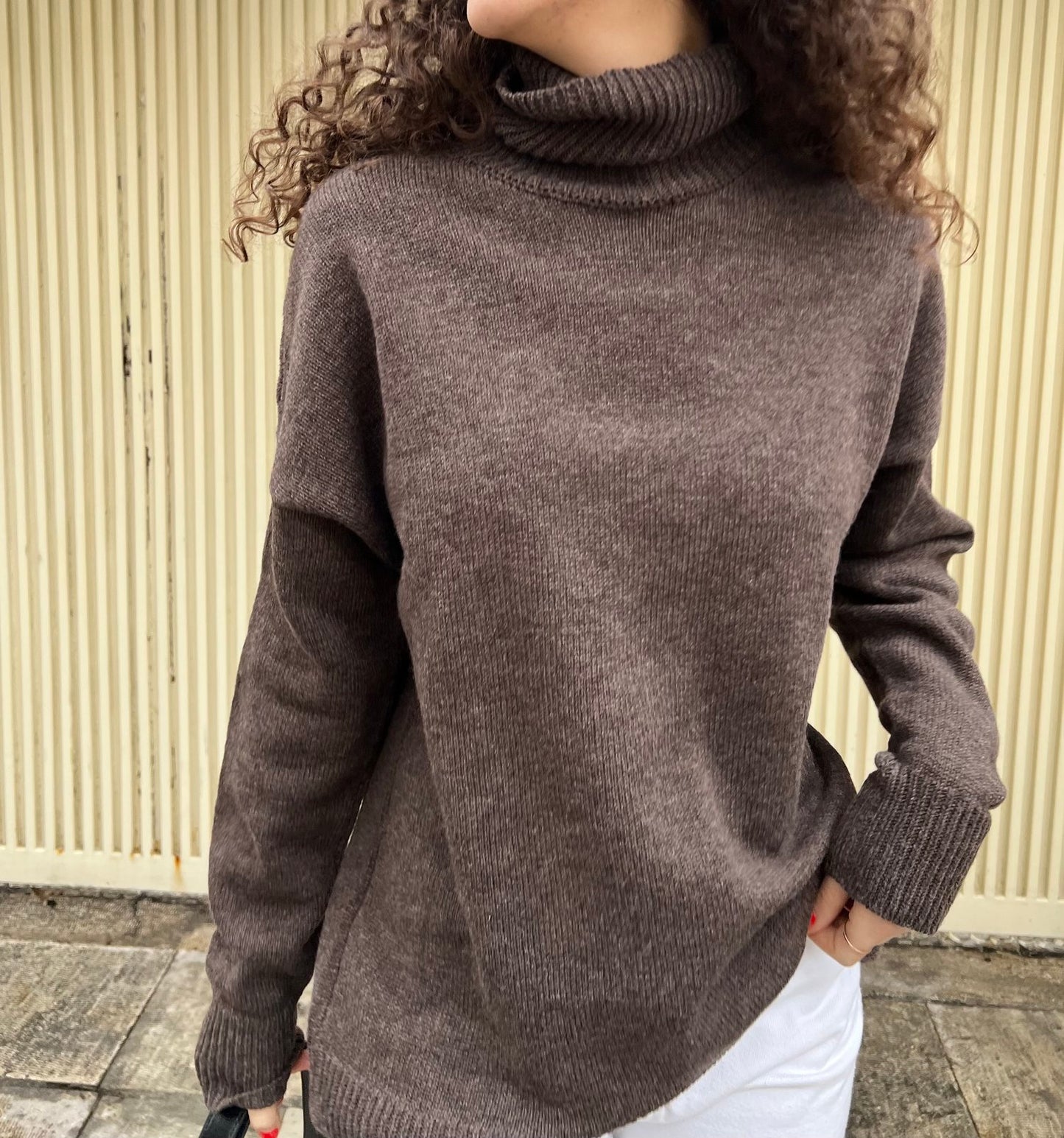 givéh knitwear handmade by female artisans in iran using only natural and recycled fibres. contemporary knitwear for cool people. turtleneck sweater in brown. 100% merino wool. fall 2025 collection.