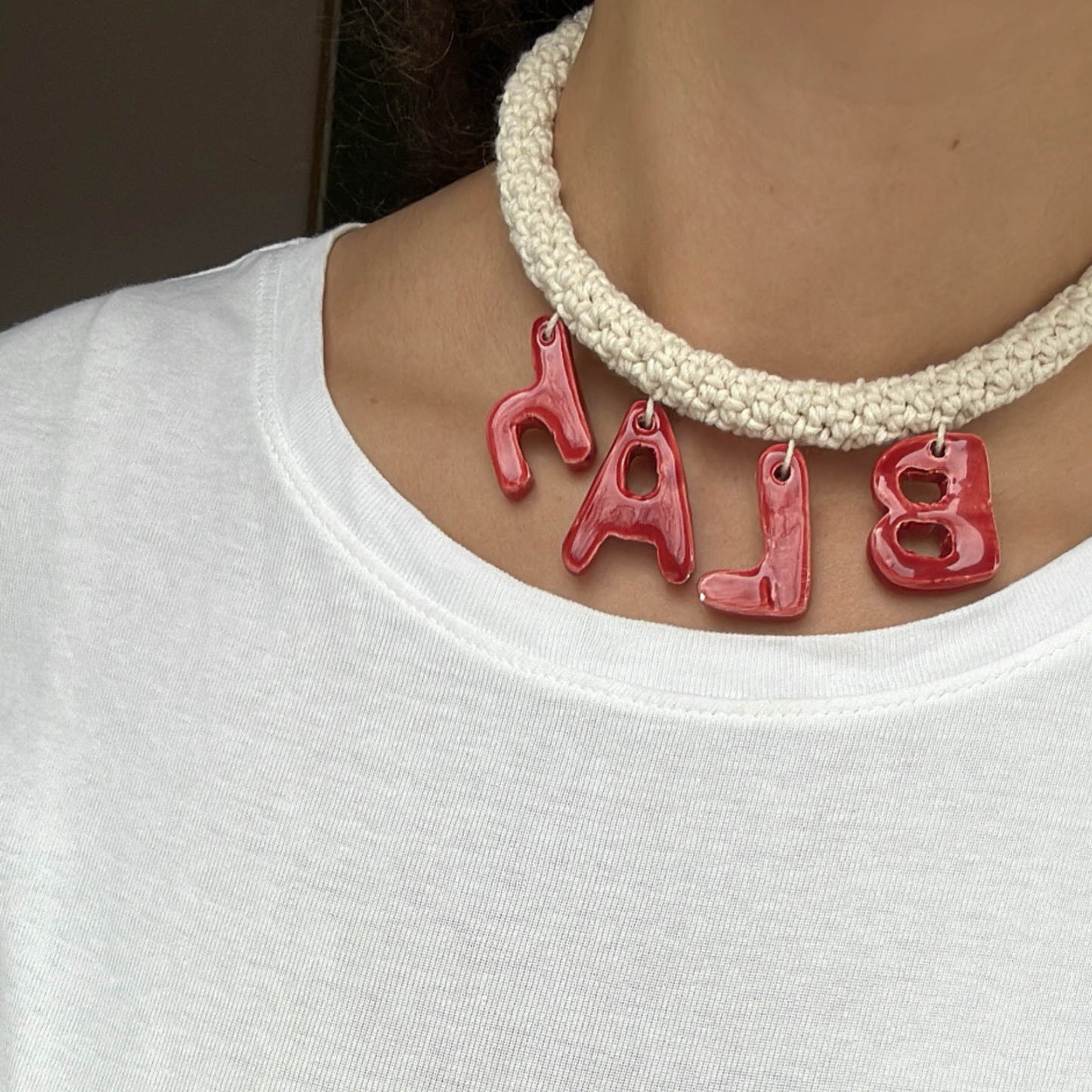 givéh knitwear handmade by female artisans in iran. blah hand crocheted undyed cotton necklace with handmade clay ceramic pendant.