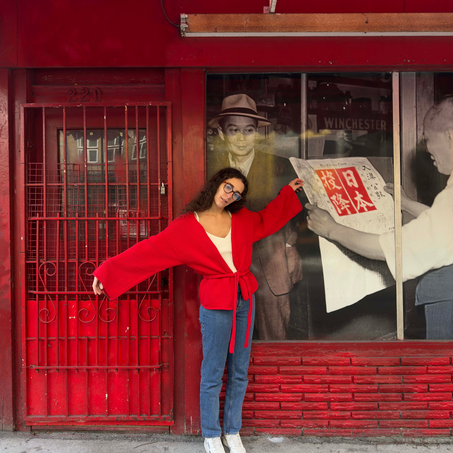 givéh knitwear handmade by female artisans in iran using only natural and recycled fibres. contemporary knitwear for cool people. chili the cardi, red knit cardigan with belt made of cotton and recycled polyamide yarn. spring summer 2025 collection.