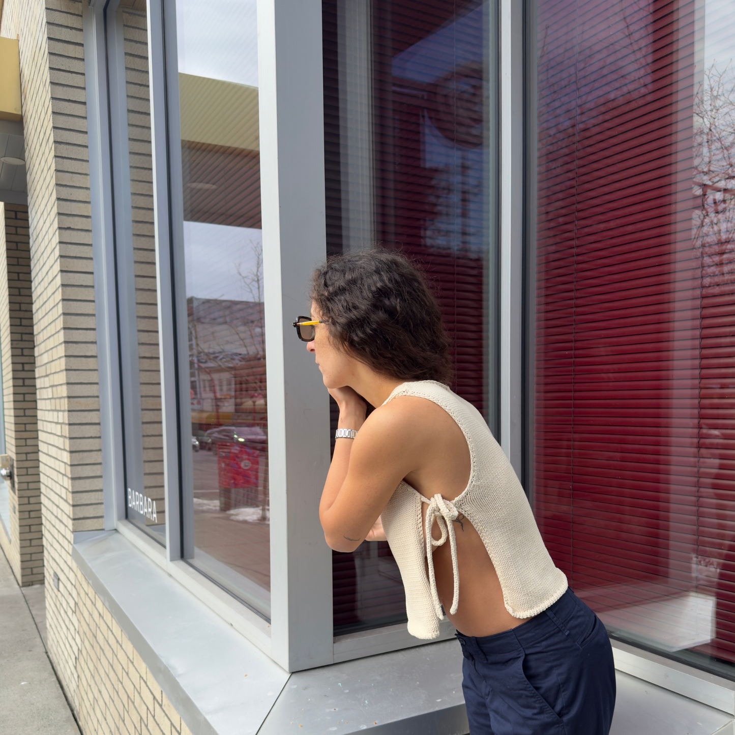 givéh knitwear handmade by female artisans in iran using only natural and recycled fibres. contemporary knitwear for cool people. cream tie top, cream open side top with tie closure and hand crocheted edges made out of cotton and recycled polyamide yarn. spring summer 2025 collection.