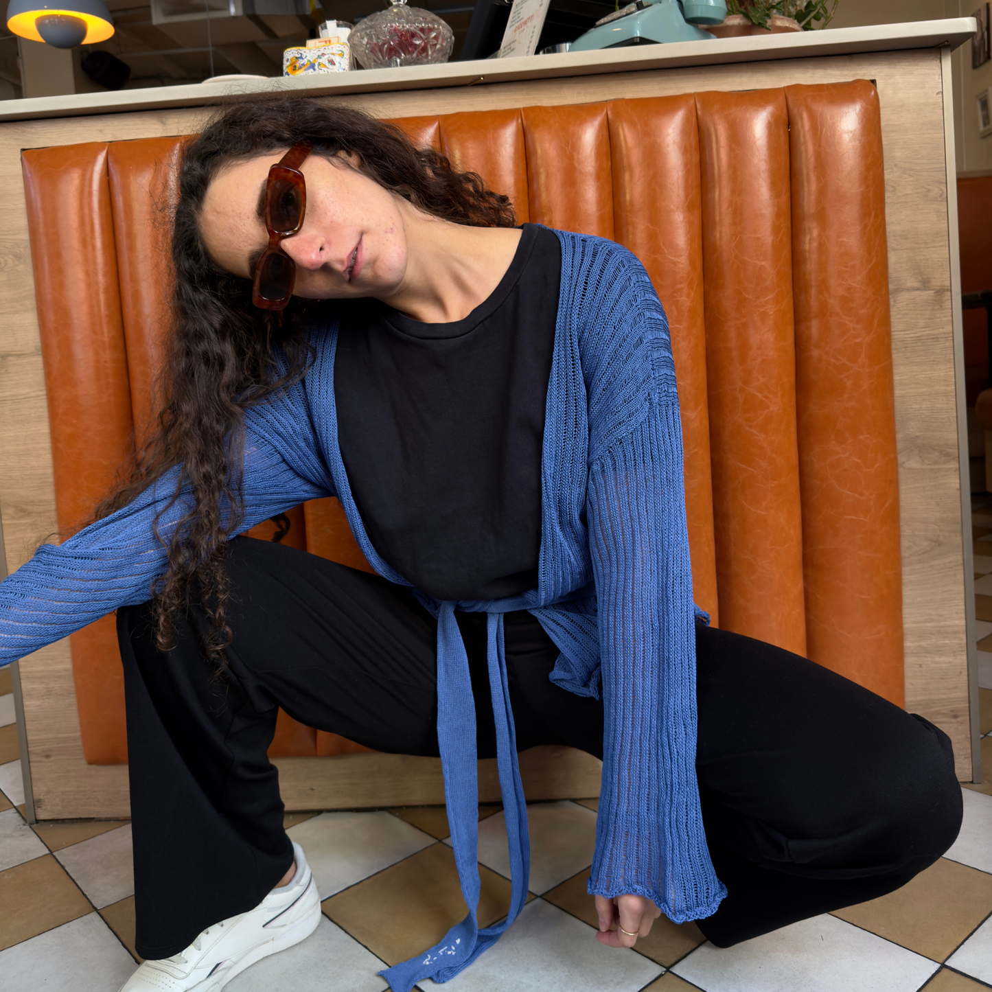givéh knitwear handmade by female artisans in iran using only natural and recycled fibres. contemporary knitwear for cool people. darya cardi, blue knit cardigan with belt made of organic cotton yarn. spring summer 2025 collection.