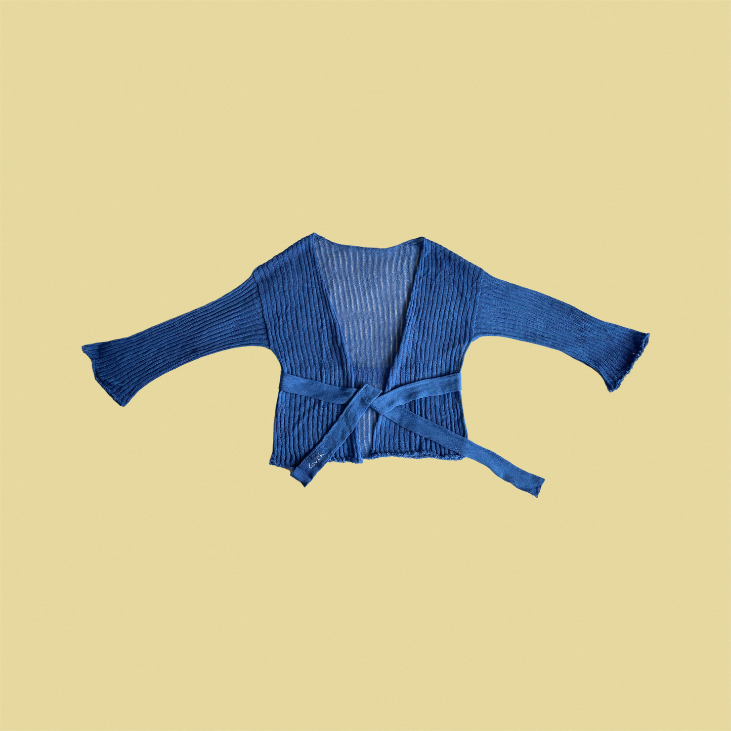 givéh knitwear handmade by female artisans in iran using only natural and recycled fibres. contemporary knitwear for cool people. darya cardi, blue knit cardigan with belt made of organic cotton yarn. spring summer 2025 collection.