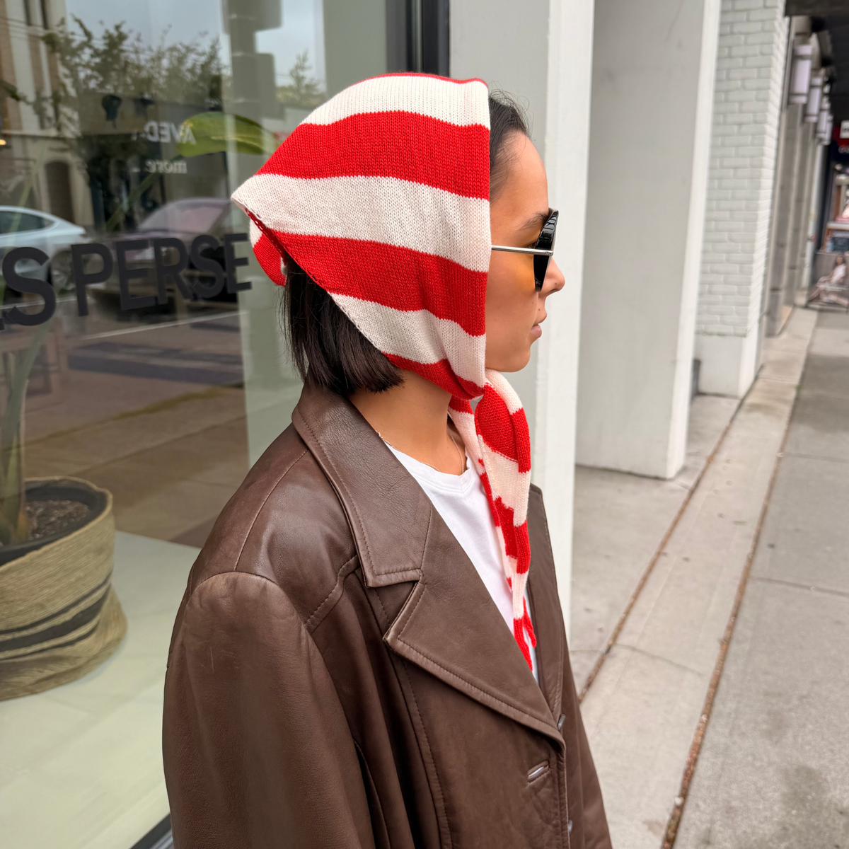 Givéh handmade merino wool cashmere-blend mini scarf by female artisans in Iran, hand embroidered lily detail in a red stripe