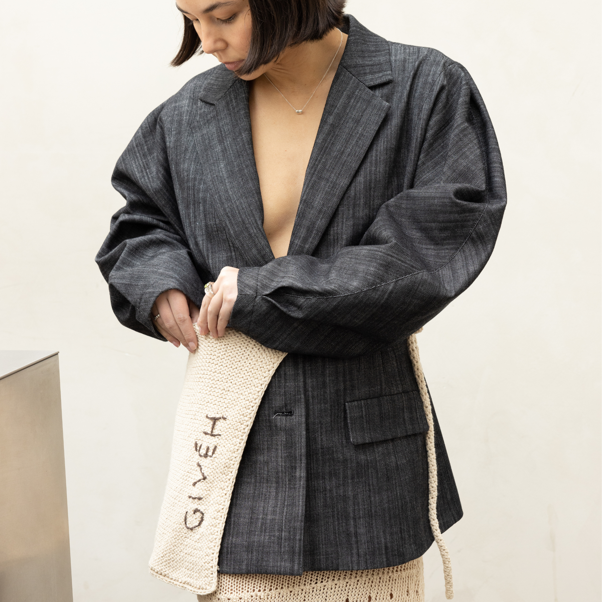 Givéh knitwear cotton hand crocheted crossbody bag by female artisans in Iran, adjustable strap, natural undyed cotton yarn. worn as a belt.