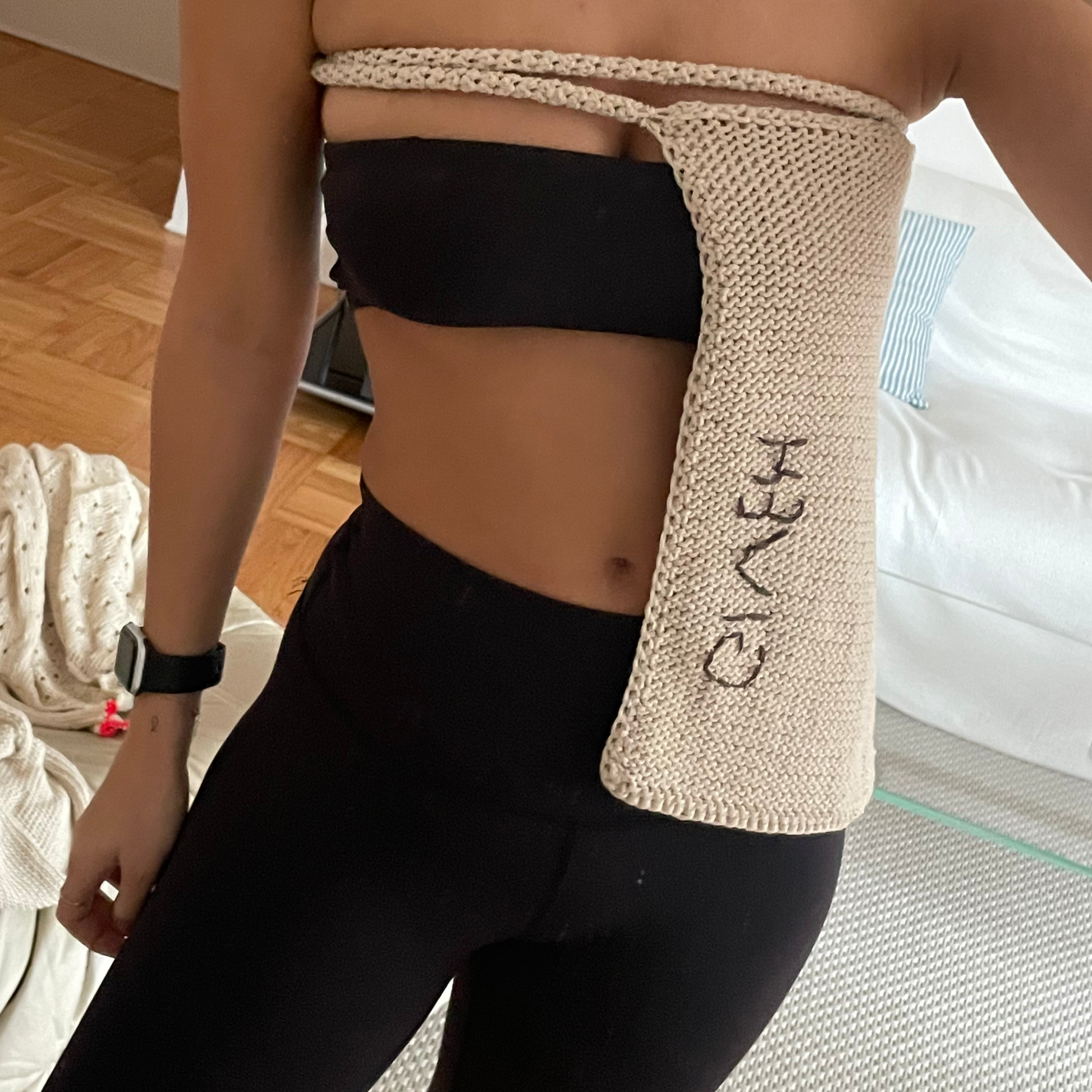 Givéh knitwear cotton hand crocheted crossbody bag by female artisans in Iran, adjustable strap, natural undyed cotton yarn. worn as a top.