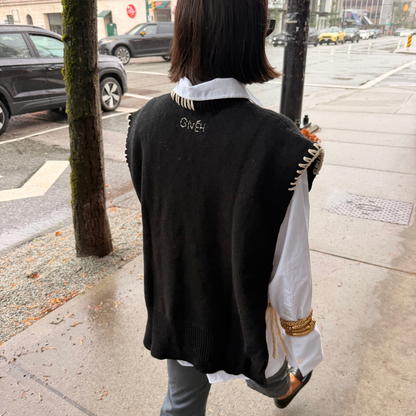 Givéh handmade merino wool cashmere-blend open-side vest by female artisans in Iran, black with cream hand crocheted trim and tie closure