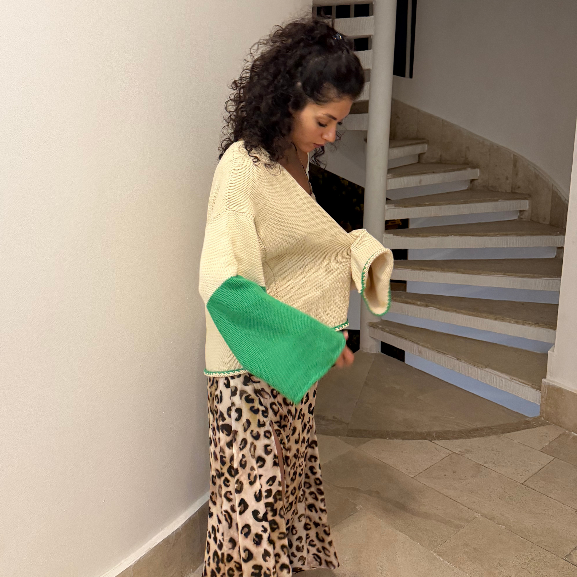 givéh knitwear handmade by female artisans in iran using only natural and recycled fibres. contemporary knitwear for cool people. cream the cardi, cream and green knit cardigan with belt made of cotton and recycled polyamide yarn. spring summer 2025 collection.