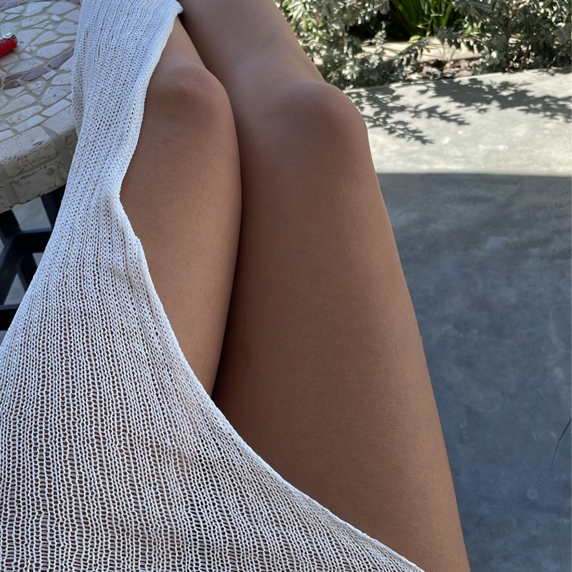 givéh knitwear handmade by female artisans in iran using only natural and recycled fibres. contemporary knitwear for cool people. white kaj skirt, asymmetrical organic cotton skirt. spring summer 2025 collection.