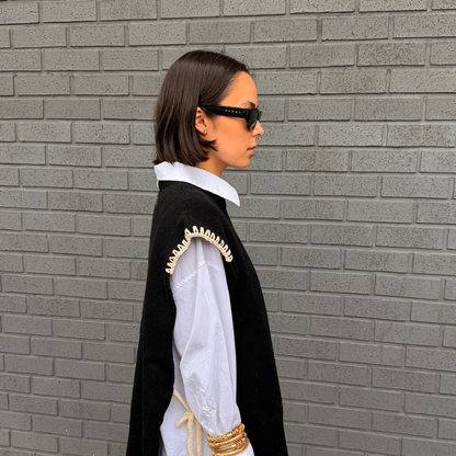 Givéh handmade merino wool cashmere-blend open-side vest by female artisans in Iran, black with cream hand crocheted trim and tie closure