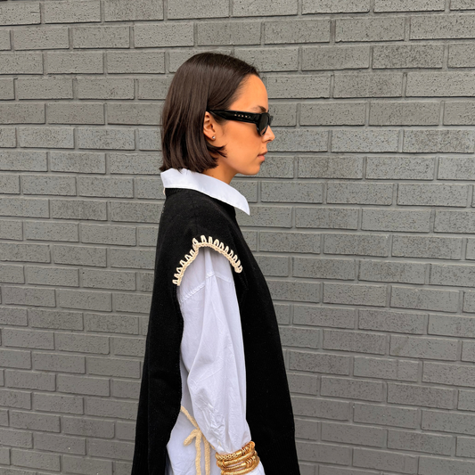 Givéh handmade merino wool cashmere-blend open-side vest by female artisans in Iran, black with cream hand crocheted trim and tie closure
