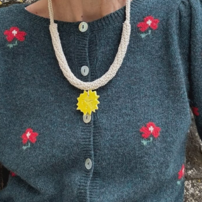 givéh knitwear handmade by female artisans in iran. aftab hand crocheted undyed cotton necklace with handmade clay ceramic pendant in the shape of the sun.