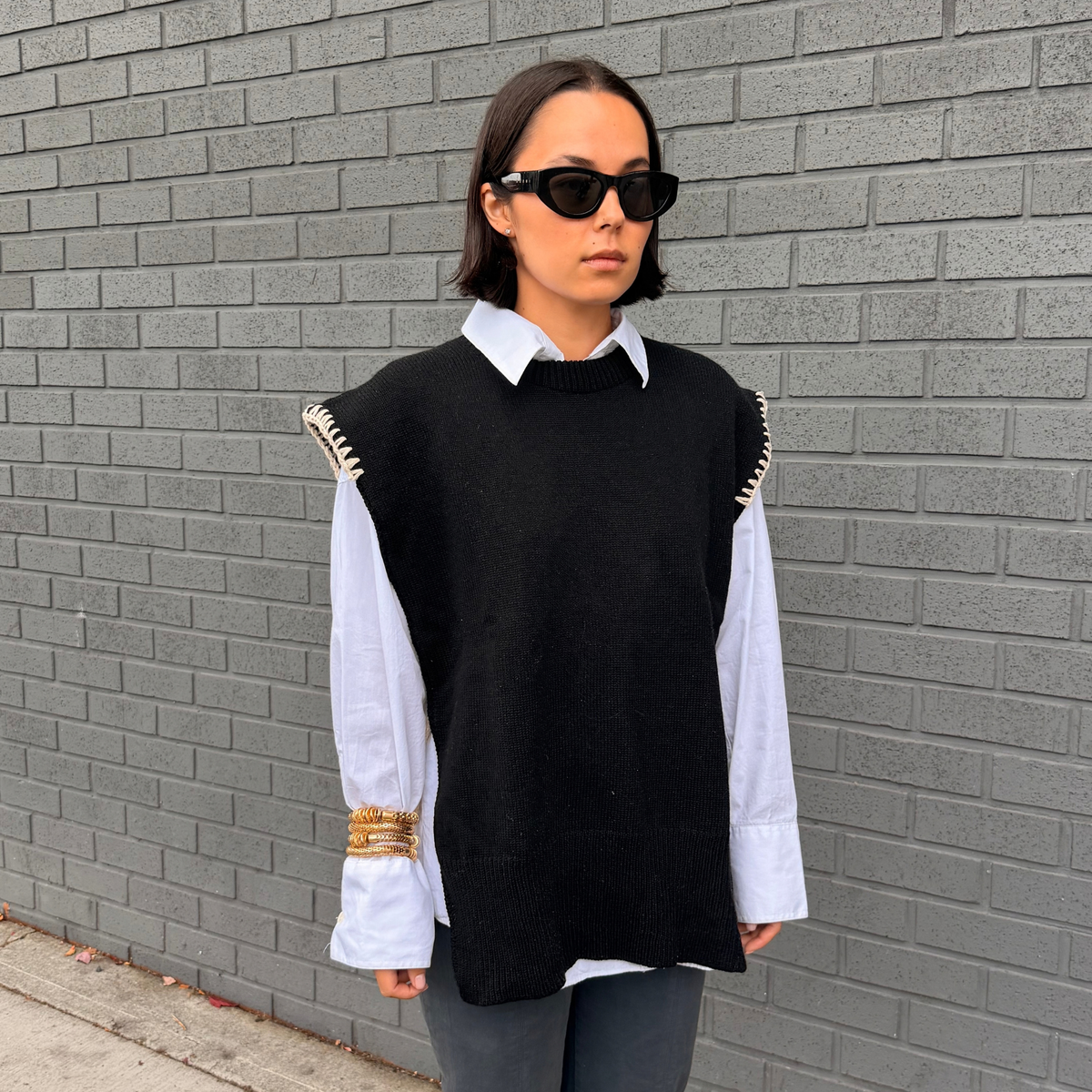 Givéh handmade merino wool cashmere-blend open-side vest by female artisans in Iran, black with cream hand crocheted trim and tie closure