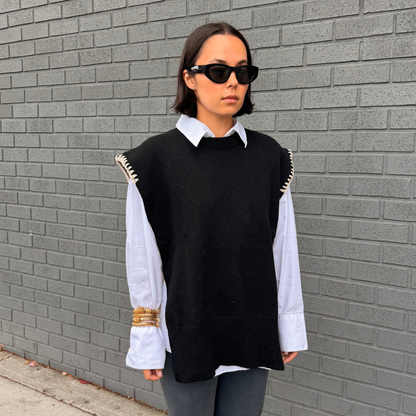 Givéh handmade merino wool cashmere-blend open-side vest by female artisans in Iran, black with cream hand crocheted trim and tie closure