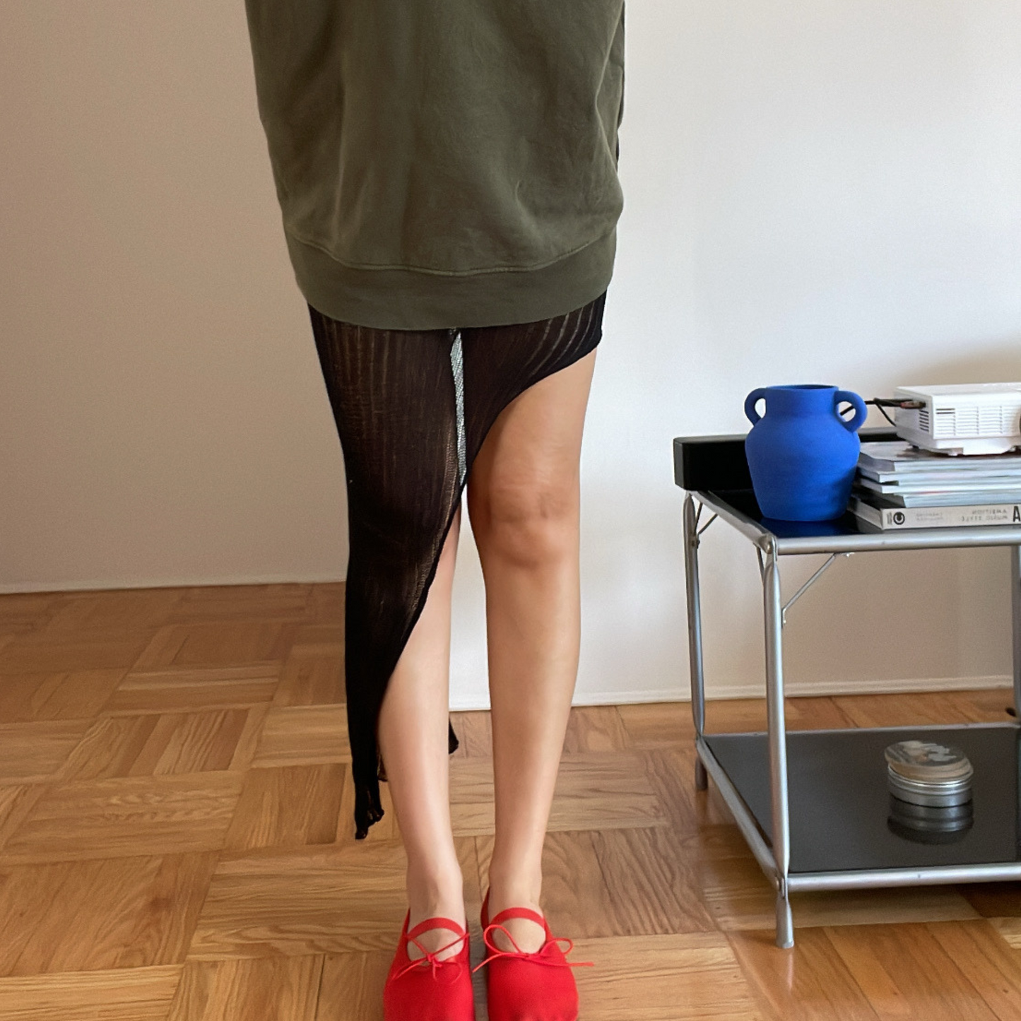 givéh knitwear handmade by female artisans in iran using only natural and recycled fibres. contemporary knitwear for cool people. black kaj skirt, asymmetrical organic cotton skirt. spring summer 2025 collection.