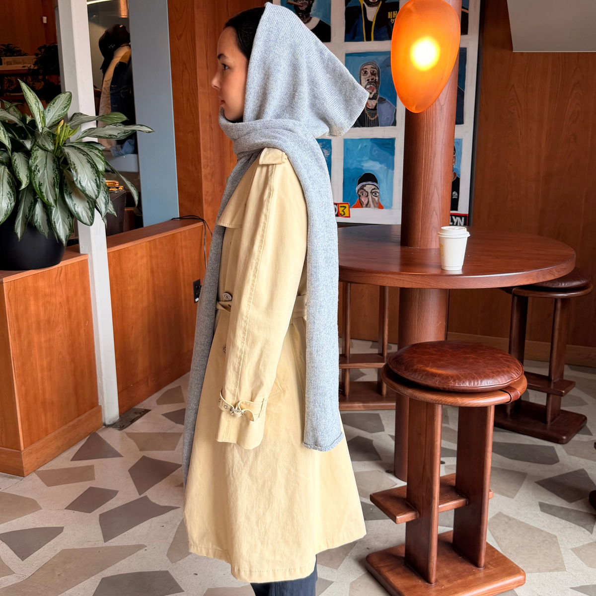 Givéh handmade merino wool cashmere-blend hooded scarf by female artisans in Iran, hand embroidered detail in grey, shown worn on model