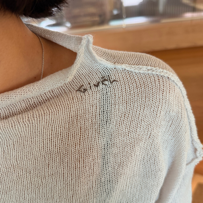 Givéh Panda mock-neck sweater in ivory, a wool and cashmere knit by female artisans in Iran with an inside-out finish and embroidered Givéh lettering at the neckline