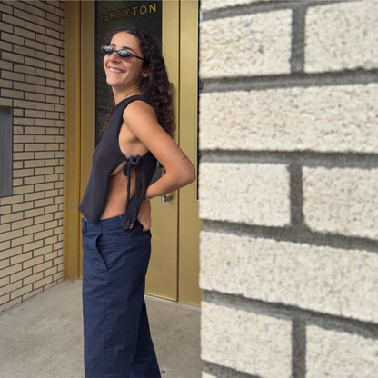 givéh knitwear handmade by female artisans in iran using only natural and recycled fibres. contemporary knitwear for cool people. black tie top, black open side top with tie closure and hand crocheted edges made out of cotton and recycled polyamide yarn. spring summer 2025 collection.
