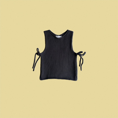 givéh knitwear handmade by female artisans in iran using only natural and recycled fibres. contemporary knitwear for cool people. black tie top, black open side top with tie closure and hand crocheted edges made out of cotton and recycled polyamide yarn. spring summer 2025 collection.