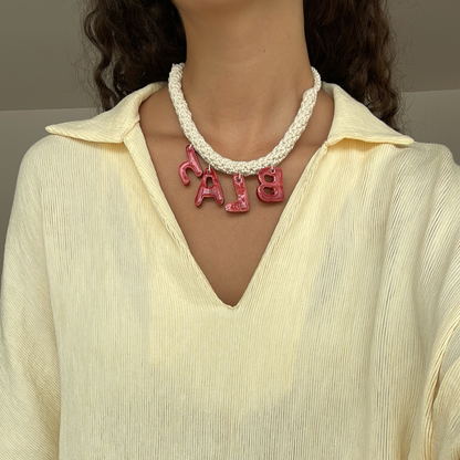 givéh knitwear handmade by female artisans in iran. blah hand crocheted undyed cotton necklace with handmade clay ceramic pendant.