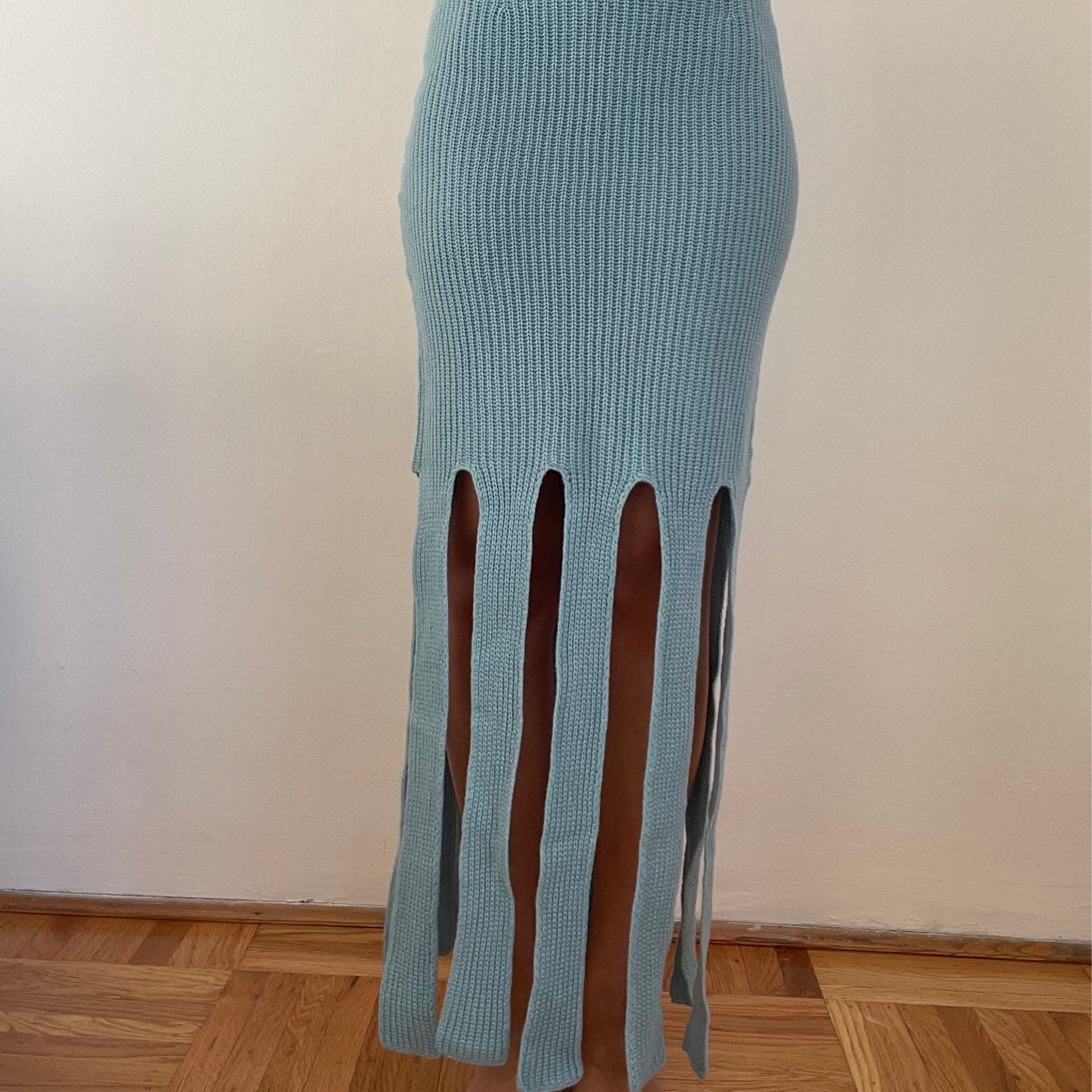givéh knitwear handmade by female artisans in iran using only natural and recycled fibres. contemporary knitwear for cool people. blue skirt with handcrocheted edges. 100% merino wool. fall 2025 collection.