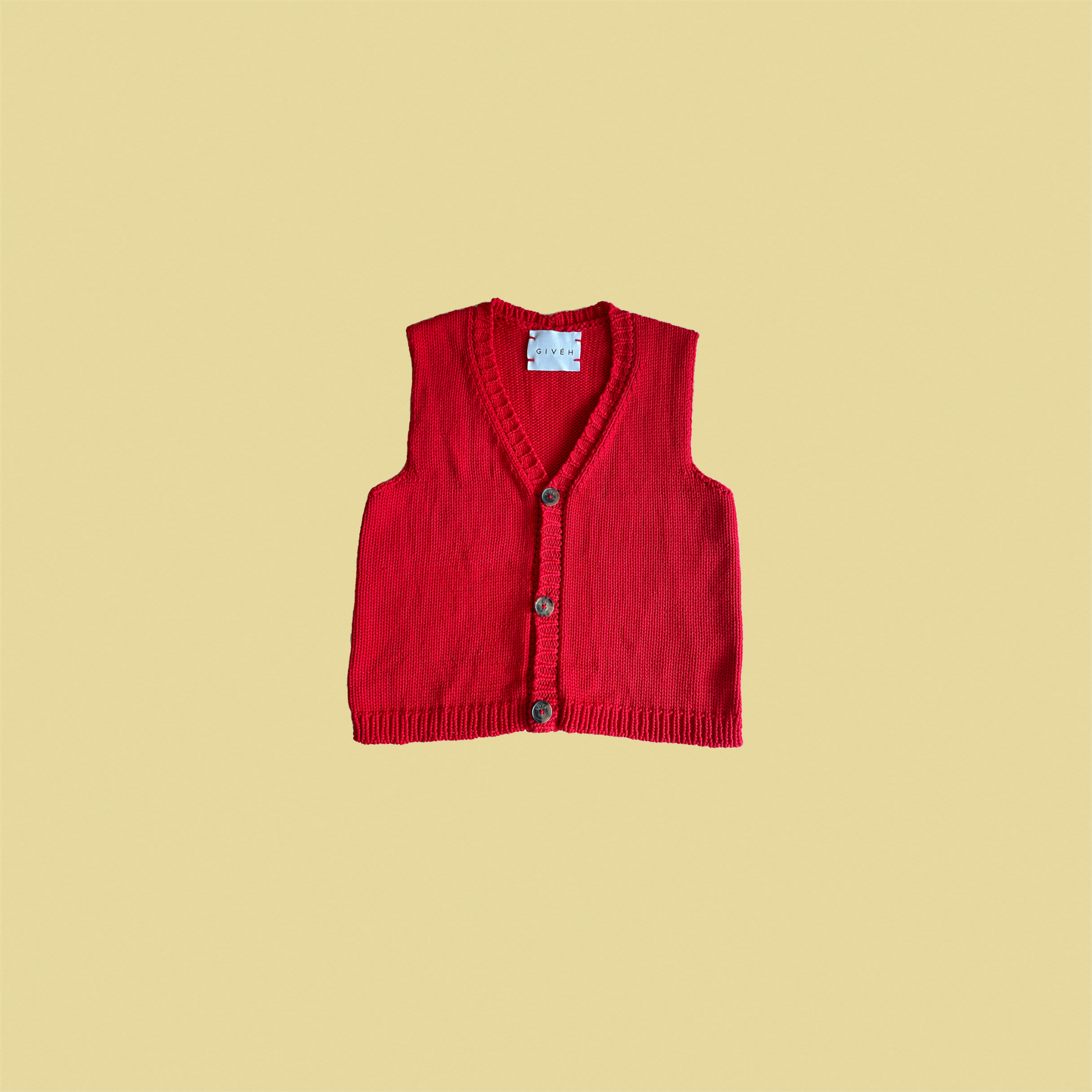 givéh knitwear handmade by female artisans in iran using only natural and recycled fibres. contemporary knitwear for cool people. red vesty vest, red knit vest with three natural horn buttons, made of cotton and recycled polyamide yarn, handcrocheted edges. spring summer 2025 collection.
