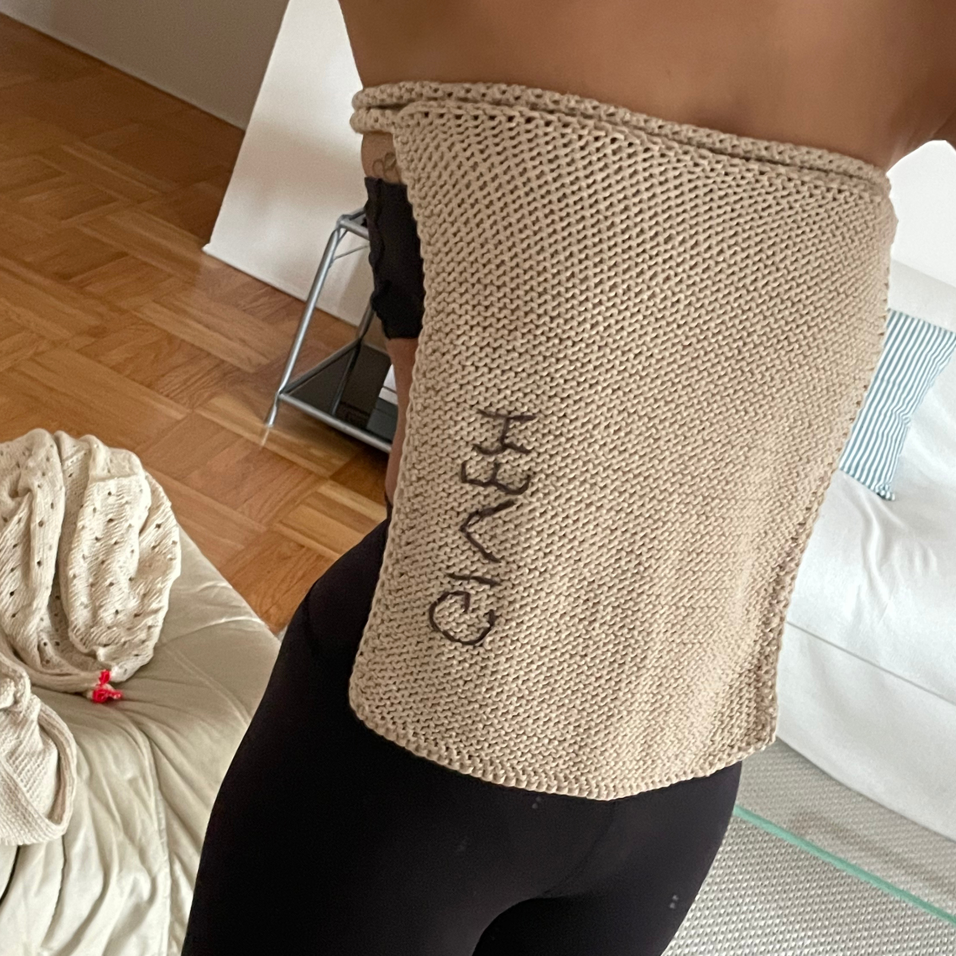 Givéh knitwear cotton hand crocheted crossbody bag by female artisans in Iran, adjustable strap, natural undyed cotton yarn. worn as a top.