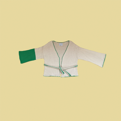 givéh knitwear handmade by female artisans in iran using only natural and recycled fibres. contemporary knitwear for cool people. cream the cardi, cream and green knit cardigan with belt made of cotton and recycled polyamide yarn. spring summer 2025 collection.