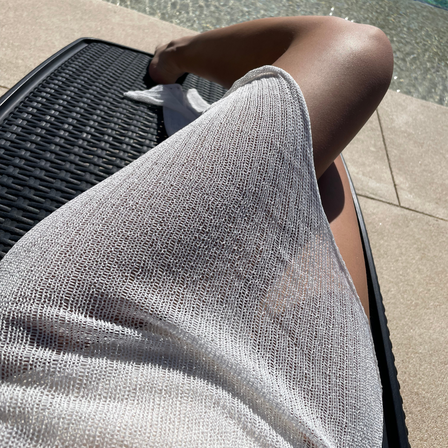givéh knitwear handmade by female artisans in iran using only natural and recycled fibres. contemporary knitwear for cool people. white kaj skirt, asymmetrical organic cotton skirt. spring summer 2025 collection.